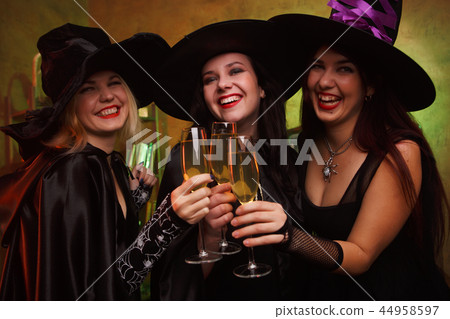 Portrait of three happy witches with glass of champagne Portrait of three happy witches with glass of champagne 44958597