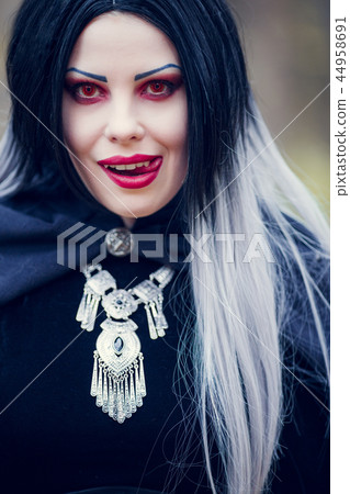 Portrait of vampire woman with long hair, red eyes Portrait of vampire woman with long hair, red eyes 44958691