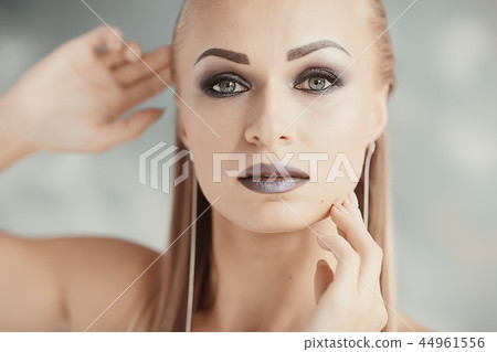 professional make-up model studio / model posing in studio with bright fresh make-up, beautiful eyes and lips with makeup 44961556