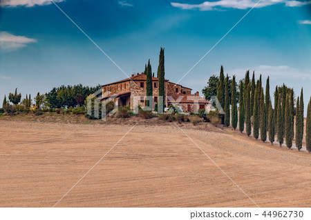 Beautiful farm house and cypresses in Tuscany Beautiful farm house and cypresses in Tuscany 44962730