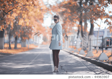 walk in autumn park / beautiful girl in autumn park, model female happiness and fun in yellow trees October 44963907