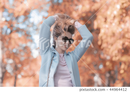 walk in autumn park / beautiful girl in autumn park, model female happiness and fun in yellow trees October 44964412