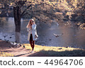 shore pond park adult girl / walk in city park, beautiful girl near pond in urban outdoor recreation area 44964706