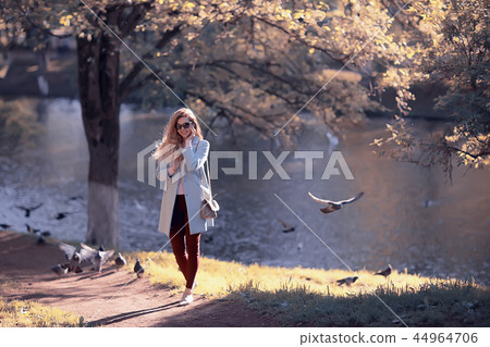 shore pond park adult girl / walk in city park, beautiful girl near pond in urban outdoor recreation area shore pond park adult girl / walk in city park, beautiful girl near pond in urban outdoor recreation area 44964706