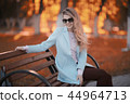 walk in autumn park / beautiful girl in autumn park, model female happiness and fun in yellow trees October 44964713