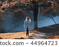 walk in autumn park / beautiful girl in autumn park, model female happiness and fun in yellow trees October 44964723