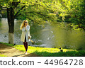 summer girl outdoor air / cheerful adult girl model on a summer walk in the city park, happiness, pleasure freedom 44964728