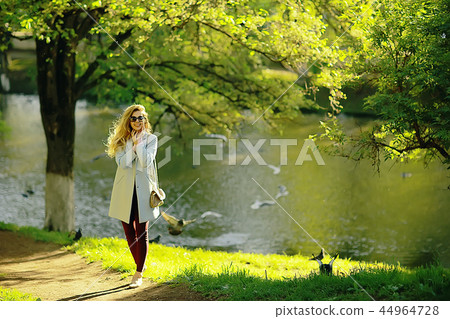 summer girl outdoor air / cheerful adult girl model on a summer walk in the city park, happiness, pleasure freedom summer girl outdoor air / cheerful adult girl model on a summer walk in the city park, happiness, pleasure freedom 44964728