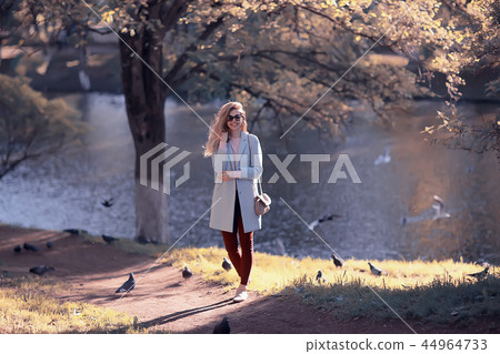 shore pond park adult girl / walk in city park, beautiful girl near pond in urban outdoor recreation area shore pond park adult girl / walk in city park, beautiful girl near pond in urban outdoor recreation area 44964733
