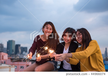 Happy group of asian girl friends play sparkler Happy group of asian girl friends play sparkler 44966074
