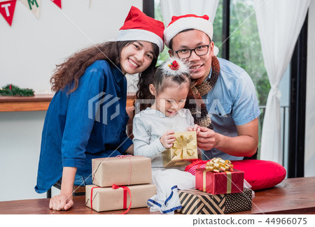 Happy family Asian family wear santa claus hat Happy family Asian family wear santa claus hat 44966075