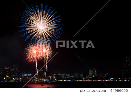Fireworks explored over cityscape at night in sea 44966090