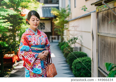 Japanese lady standing in garden in sunny day Japanese lady standing in garden in sunny day 44966834