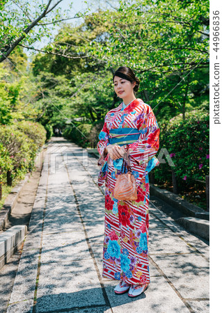 lady with colorful kimono standing in garden lady with colorful kimono standing in garden 44966836
