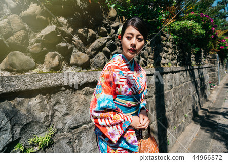 Japanese lady relaxing relying on the stone wall Japanese lady relaxing relying on the stone wall 44966872