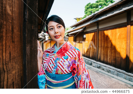 Japanese Girl Peeping Her Dating Guy In Alley Stock Photo