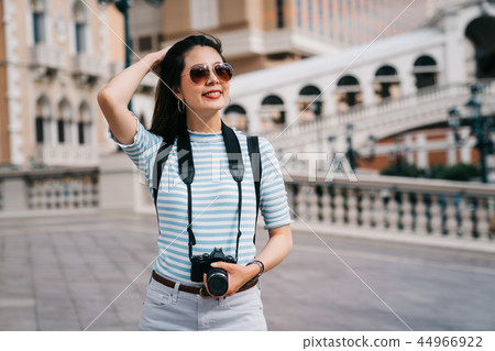 wind blowing the beautiful traveler's long hair 44966922