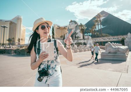 tourist standing in front of the sphinx in egypt 44967095