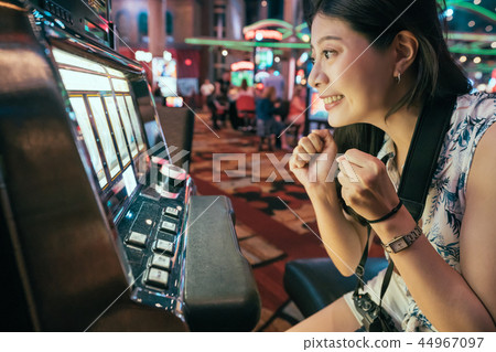 Asian gambling in casino playing slot machines Asian gambling in casino playing slot machines 44967097