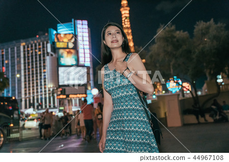 city Asian girl walking on street at night 44967108
