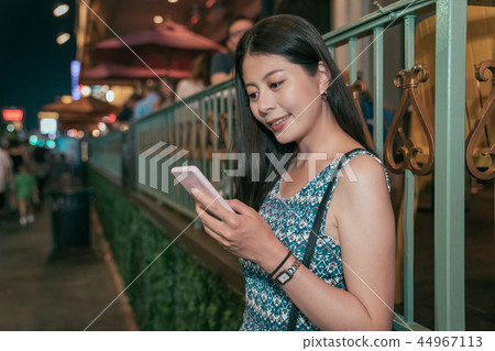 young asian girl relying outside the restaurant 44967113
