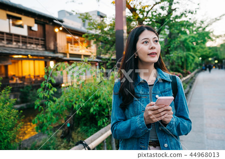 a modern lady seeing at the sunset 44968013