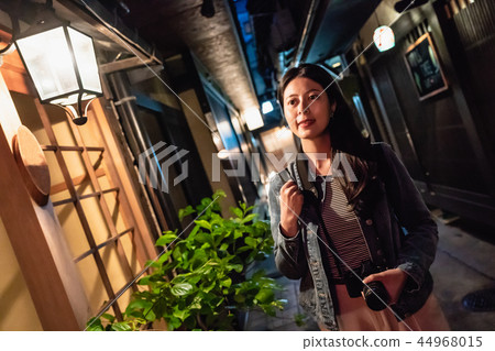 a beautiful lady walking alone on a path at night a beautiful lady walking alone on a path at night 44968015