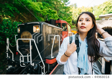 traveler standing in front of the famous train 44968018