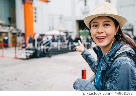 traveler pointing to the Chinese Theatre 44968192