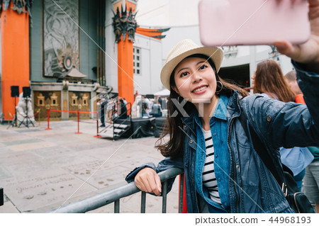 traveler taking selfie with the Chinese Theatre 44968193