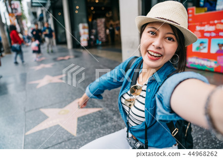 tourist taking selfie with the star sign 44968262