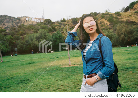 an elegant female tourist flicks her hair an elegant female tourist flicks her hair 44968269