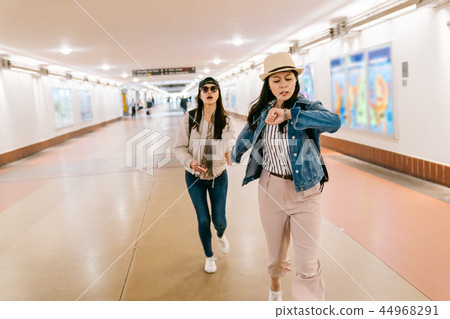 asian sisters are in a rush to catch the train asian sisters are in a rush to catch the train 44968291