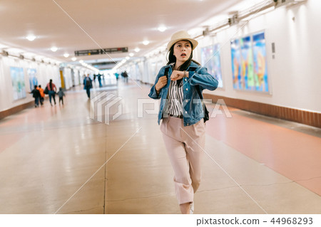 lady is running trying to catch the train 44968293