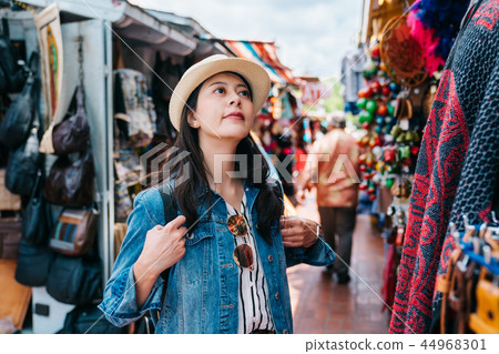 traveler looking at the colorful textile cloth 44968301