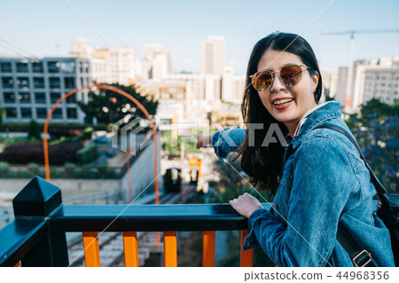 traveler curiously pointing to the railcar 44968356