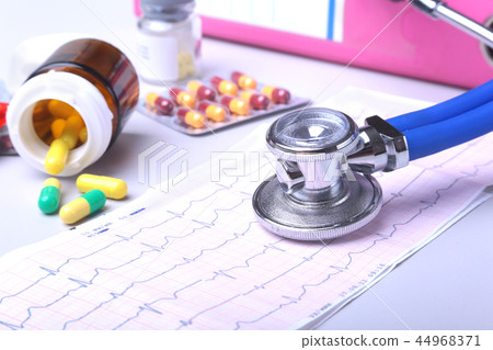 Close-up stethoscope lying on RX prescription with assorted pills. Healthy life or insurance concept 44968371