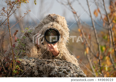 Wildlife photographer in the ghillie suit working Wildlife photographer in the ghillie suit working 44969019
