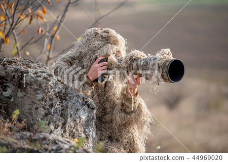 Wildlife photographer in the ghillie suit working Wildlife photographer in the ghillie suit working 44969020
