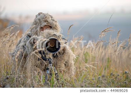 Wildlife photographer in the ghillie suit working Wildlife photographer in the ghillie suit working 44969026