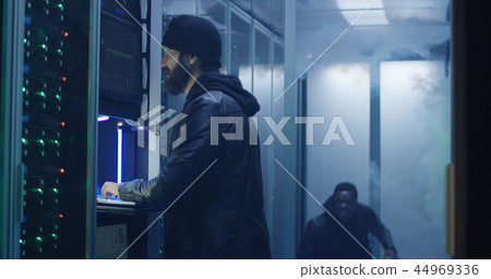 Two hackers finishing hack and escaping a smoke-filled room 44969336