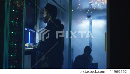 Two hackers finishing attack and escaping a smokey data center 44969362