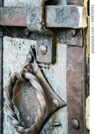 old and rusty latch and handle on metal door  44970091