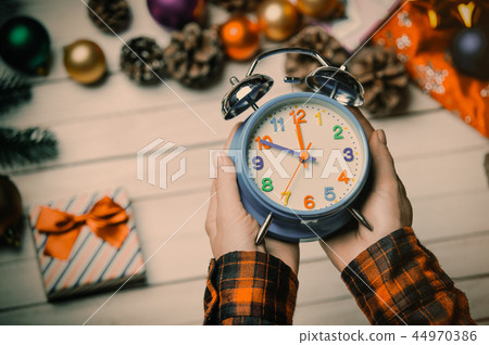 child hands holding a clock child hands holding a clock 44970386