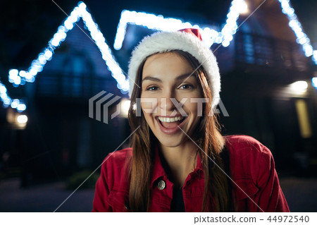 Positive beautiful woman wearing a festive hat 44972540