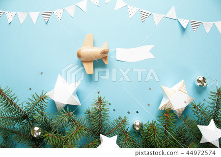 Children's wooden plane in the sky carries an empty banner. 44972574