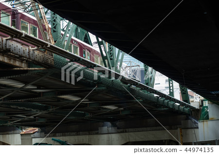 Iron bridge and Hankyu train to look up from Osaka Nakazu under the overpass Iron bridge and Hankyu train to look up from Osaka Nakazu under the overpass 44974135
