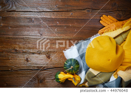 Autumn clothes top down view on wooden table Autumn clothes top down view on wooden table 44976048