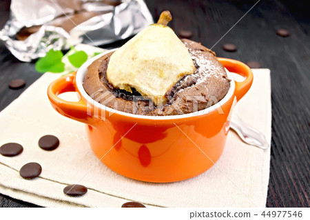 Cake chocolate with pear in red bowl on towel 44977546