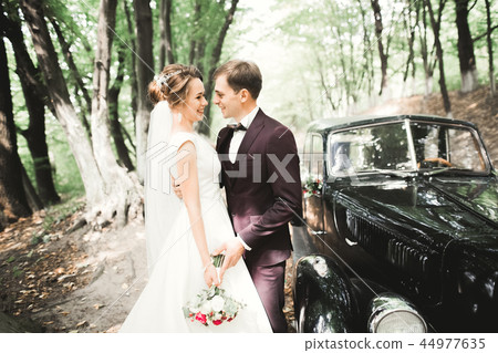 Perfect couple bride, groom posing and kissing in their wedding day 44977635